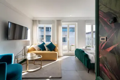 a living room with a couch and a tv at Charming apartment in Cedofeita by Lisbeyond in Porto
