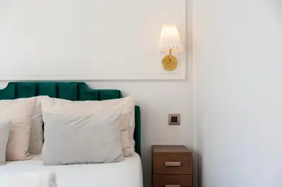 a bed with a green headboard and white pillows at Charming apartment in Cedofeita by Lisbeyond in Porto
