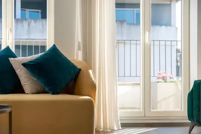 a living room with a chair and a window at Charming apartment in Cedofeita by Lisbeyond in Porto