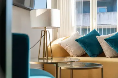 a living room with a couch with blue and white pillows at Charming apartment in Cedofeita by Lisbeyond in Porto