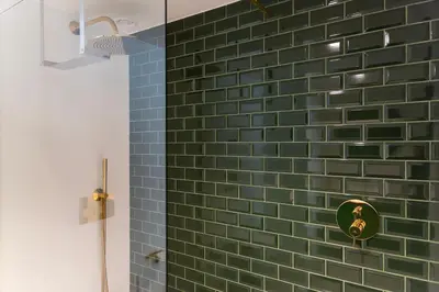 a green tiled bathroom with a green tile wall at Charming apartment in Cedofeita by Lisbeyond in Porto