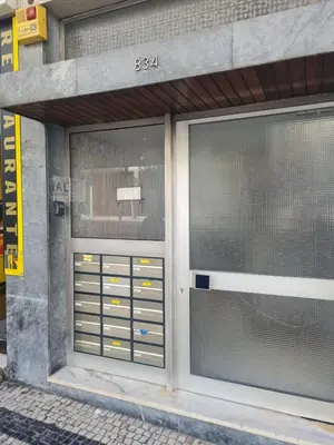a building with two glass doors on a street at Douro Sunset Terrace in Vila Nova de Gaia