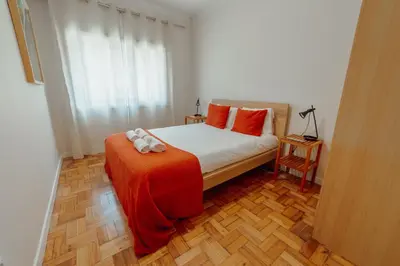 a bedroom with a bed with orange pillows at Cedofeita Terrace by Hosty in Porto