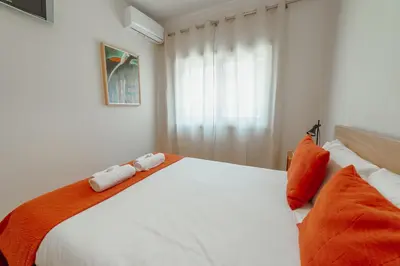a bedroom with a white bed with two towels on it at Cedofeita Terrace by Hosty in Porto