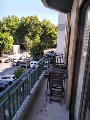 a bench on a balcony with a view of a parking lot at Covelo in Porto