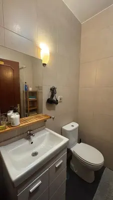 a bathroom with a white toilet and a sink at Covelo in Porto