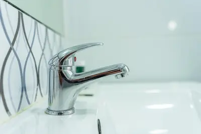 a bathroom sink with a chrome faucet at Happy's Apartments in Porto