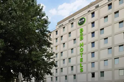a building with a clock on the side of it at B&B HOTEL Porto Centro Massarelos in Porto