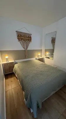 a bedroom with a large bed and a mirror at Apartamento Fontinha in Porto