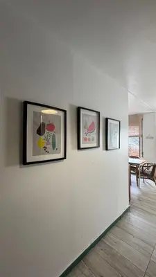 three framed pictures on a wall with a dining room at Apartamento Fontinha in Porto