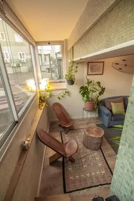 a room with a couch and a chair and a window at Amy's Place in Porto