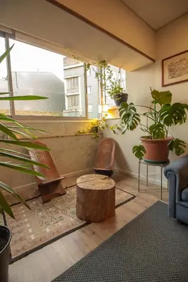 a living room filled with lots of potted plants at Amy's Place in Porto