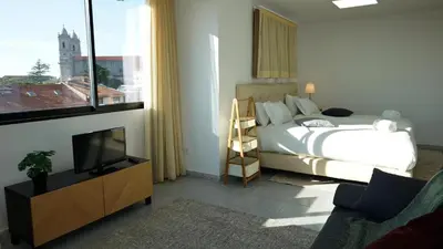 a bedroom with a bed and a flat screen tv at Ryamen Inn B in Porto