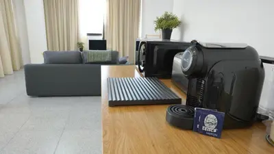 a computer printer sitting on a table in a living room at Ryamen Inn B in Porto
