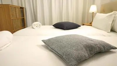 a bedroom with a bed with a pillow on it at Ryamen Inn B in Porto