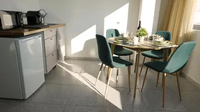 a kitchen with a table and chairs in a kitchen at Ryamen Inn B in Porto