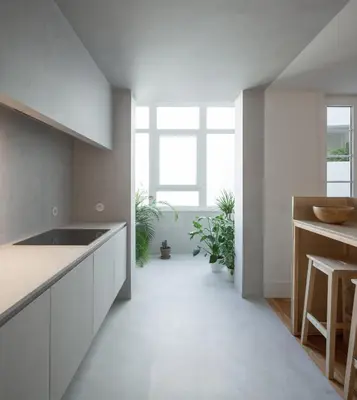 a kitchen with white counters and a large window at Santa Catarina 555 T4 in Porto
