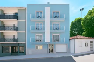 an apartment building with chairs on the balconies at Blue Hotel Oporto in Porto
