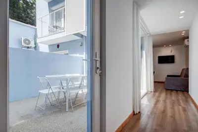 a dining room and living room with a table and chairs at Blue Hotel Oporto in Porto