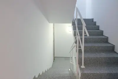 a staircase in a building with a white wall at Blue Hotel Oporto in Porto