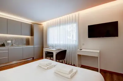 a bedroom with a bed and a desk and a tv at Blue Hotel Oporto in Porto