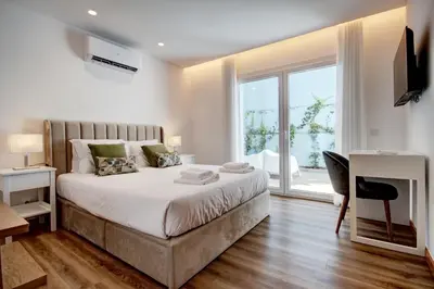 a bedroom with a large bed and a large window at Blue Hotel Oporto in Porto