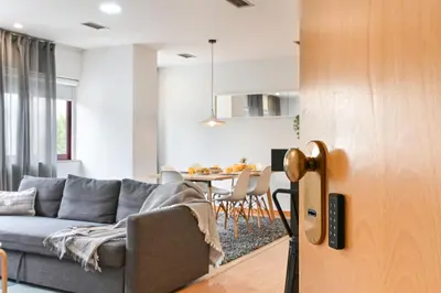 a living room with a couch and a table at Boavista Residence T3 in Porto