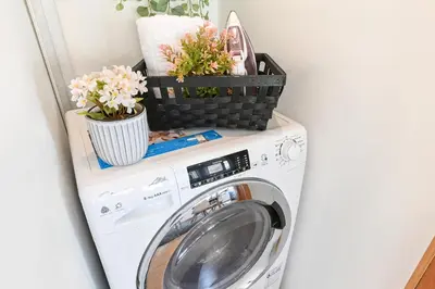 a washing machine with plants on top of it at Boavista Residence T3 in Porto