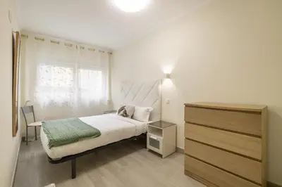 a white bedroom with a bed and a window at D&S - Torne 187 in Vila Nova de Gaia