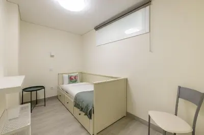 a small bedroom with a bed and a window at D&S - Torne 187 in Vila Nova de Gaia