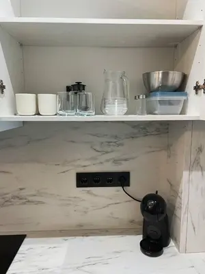 a shelf with bowls and other dishes on it at Cantinho da Boavista in Porto