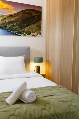 a towel on a bed in a hotel room at Lighthouse by MyMoradia I Vue & Élégance à Porto in Porto