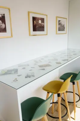 a white counter with green chairs in a room at Lighthouse by MyMoradia I Vue & Élégance à Porto in Porto