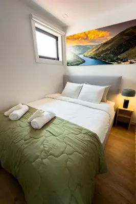 a bedroom with a bed and a painting on the wall at Lighthouse by MyMoradia I Vue & Élégance à Porto in Porto