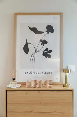 a framed picture of a flower on a dresser at Douro Tower Loft - Shared Pool in Vila Nova de Gaia