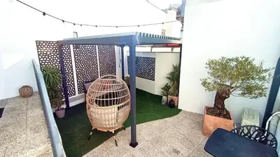 a bird cage sitting on top of a balcony at Private Terrace at Flores Street in Porto