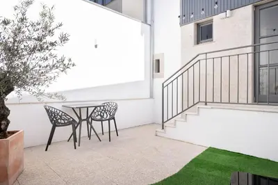 a patio with two chairs and a table on a building at Private Terrace at Flores Street in Porto