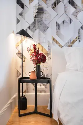 a table with a vase on it next to a bed at Private Terrace at Flores Street in Porto