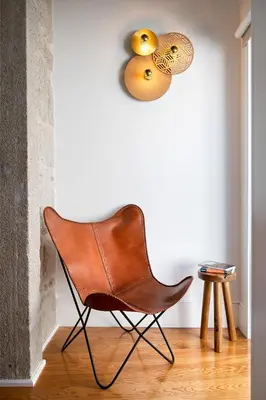 a brown leather chair in a room with a wall at Private Terrace at Flores Street in Porto