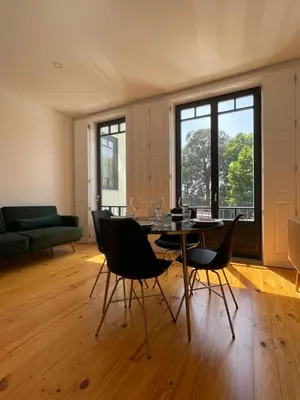 a living room with a table and chairs and a couch at MariPinto Downtown Apartment in Porto