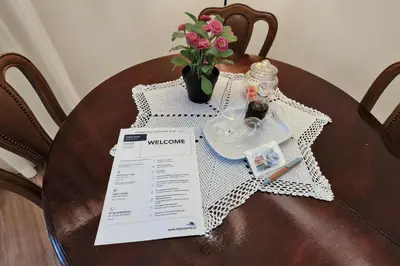 a table with a white table cloth and a vase with flowers at Vintage Copio Apartment in Vila Nova de Gaia