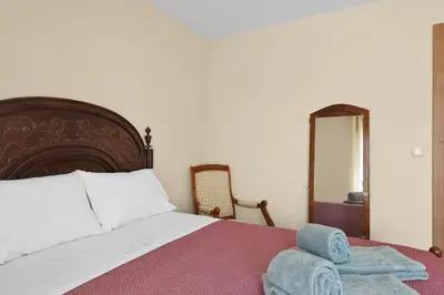 a bedroom with a large bed and a mirror at Vintage Copio Apartment in Vila Nova de Gaia
