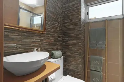 a bathroom with a sink and a toilet and a mirror at Vintage Copio Apartment in Vila Nova de Gaia