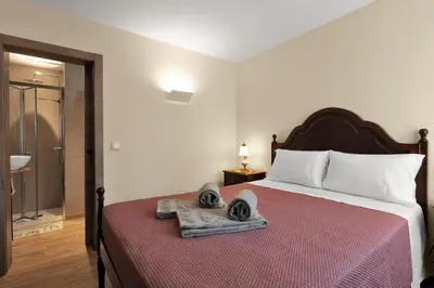 a hotel room with a bed with towels on it at Vintage Copio Apartment in Vila Nova de Gaia