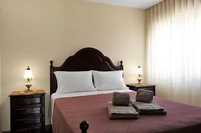 a bedroom with a large bed with two towels on it at Vintage Copio Apartment in Vila Nova de Gaia