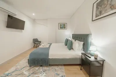 a bedroom with a bed and a desk and a television at Downtown Gold Bolhao by Vacationy in Porto