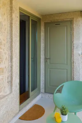 a green door and a table next to a door at Lifestyle at Porto by Upperground in Porto