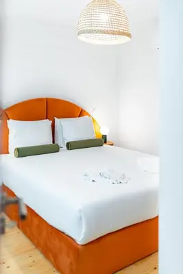 a bed with a wooden headboard in a room at Lifestyle at Porto by Upperground in Porto