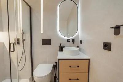 a bathroom with a toilet and a sink and a mirror at Downtown Premium With Balcony by Vacationy in Porto