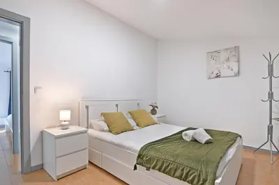 a white bedroom with a white bed with yellow pillows at The Porto Way in Porto